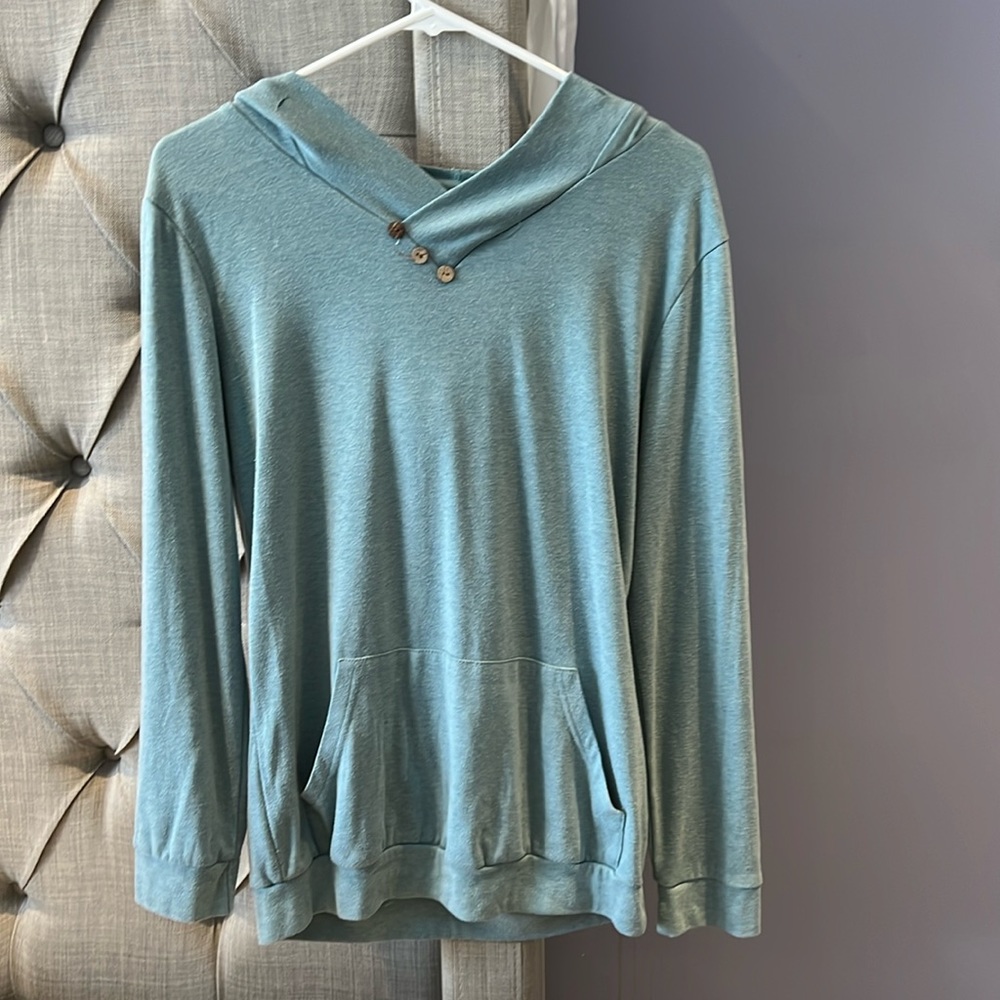Sweater color baby blue with no tags or brand, size M.